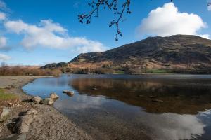 a view of a lake with a mountain in the background at The Ullswater Inn- The Inn Collection Group in Glenridding