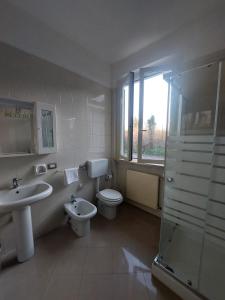 a bathroom with a toilet and a sink and a shower at Il Portichetto in Rivergaro