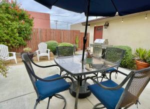 a table and chairs with an umbrella on a patio at National City Gem 3 BD 2 5 BTH in National City