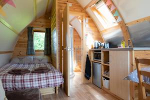 a small bedroom with a bed in a tiny house at Sedgewell Barn in Northallerton