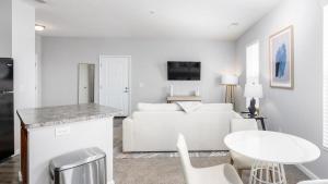 a white living room with a white couch and a table at Landing Modern Apartment with Amazing Amenities (ID8114X65) in Dublin