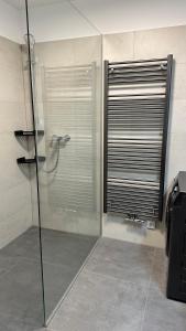 a shower with a glass door in a bathroom at Apartmán Krakonoš 431 in Pec pod Sněžkou