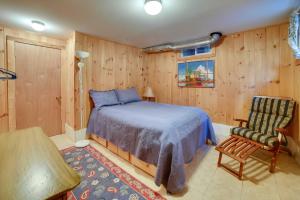 1 dormitorio con 1 cama y 1 silla en Lakefront Bradford Cottage with Dock, Near Skiing!, en Bradford
