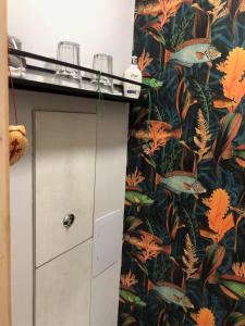 a room with a wall with a tropical wallpaper at Barwell Manor - Master room 