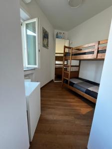 a bedroom with two bunk beds and a sink at Gaiola N 7 in Naples