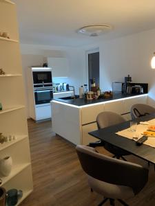 a kitchen with a table and chairs in a room at Nefer, Haus in Bad Gastein