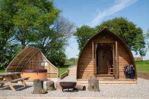 a small wooden house with a bench and a table at Sedgewell Barn in Northallerton