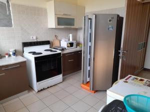 a kitchen with a stove and a refrigerator at Serena Beach View Apartment in Mombasa