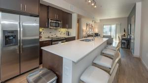 a kitchen with a white counter and a refrigerator at Landing Modern Apartment with Amazing Amenities (ID6842X82) in West Sacramento