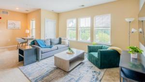 a living room with a couch and a table at Landing Modern Apartment with Amazing Amenities (ID2284) in Ellicott City