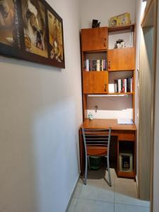 a desk with a chair next to a book shelf at Cute Studio near Yad Vashem FREE street parking in Jerusalem