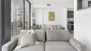 a living room with a couch and a kitchen at Landing - Modern Apartment with Amazing Amenities (ID1401X725) in Fort Lauderdale