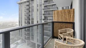 a balcony with two chairs and a large building at Landing - Modern Apartment with Amazing Amenities (ID1401X725) in Fort Lauderdale