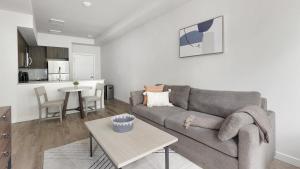 a living room with a couch and a table at Landing - Modern Apartment with Amazing Amenities (ID1403X373) in Portland