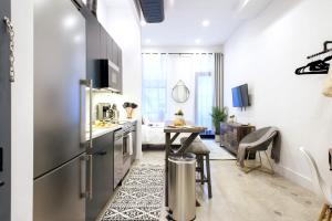 a kitchen with a stainless steel refrigerator and a table at 3-1 New Prime East Village Private Terrace in New York