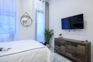 a bedroom with a flat screen tv on a wall at 3-1 New Prime East Village Private Terrace in New York