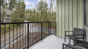 a balcony with two chairs and a fence at Landing - Modern Apartment with Amazing Amenities (ID1403X373) in Portland