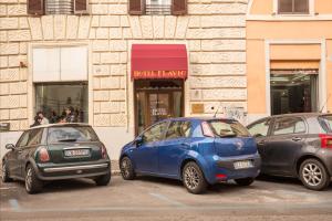 three cars parked in a parking lot in front of a building at Hotel Flavio in Rome