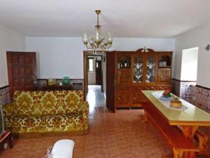 a living room with a couch and a chandelier at One bedroom house with terrace and wifi at Miranda do Corvo in Vale de Colmeias