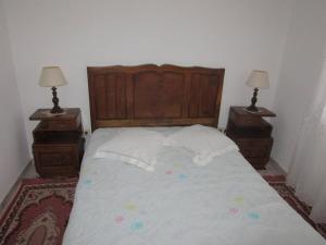 a bedroom with a large bed with two night stands at One bedroom house with terrace and wifi at Miranda do Corvo in Vale de Colmeias