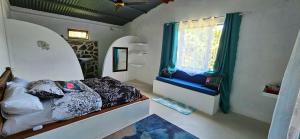 Tempat tidur dalam kamar di Le lataniers