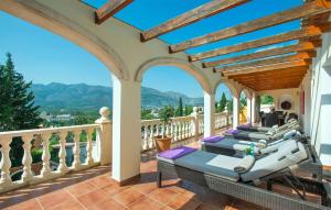 a patio with several lounge chairs on a balcony at casa del bosque in Orba