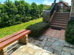 a wooden bench sitting next to a set of stairs at 2 bedrooms chalet with terrace and wifi at Orena in Oreña