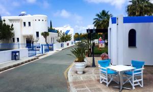 a table and chairs on the side of a road at Azzurro Holiday Villas in Peyia