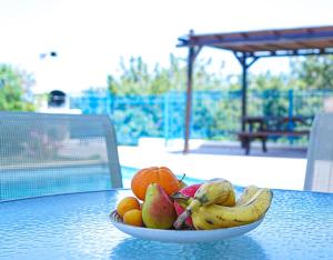 a bowl of fruit sitting on a table at Azzurro Holiday Villas in Peyia