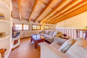 a living room with two couches and a table at Villa Can Martin by Sealand Villas in Pollença