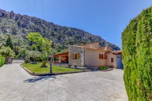 a house with a mountain in the background at Villa Can Martin by Sealand Villas in Pollença