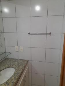 bagno bianco con lavandino e specchio di Villa damasco a Fortaleza