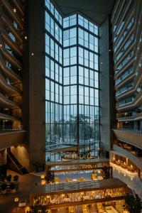 a view of the lobby of a building with large windows at Torre Melina, a Gran Meliá Hotel in Barcelona