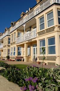 a large building with a balcony on top of it at Trem Y Mor - Edge of the Sea in Tywyn