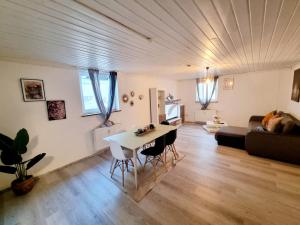 a living room with a table and a couch at Cosy Apartment in Groß-Rohrheim – 87 m² – Sunny Terrace in Groß-Rohrheim
