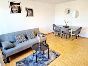 a living room with a couch and a table at 2 bedrooms appartement with balcony and wifi at Neckarau Mannheim in Neckarau