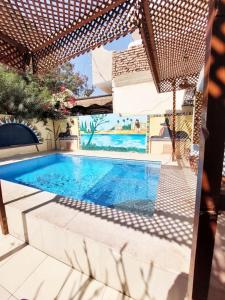 a swimming pool in the middle of a house at Villa Cleopatra Luxor west bank in Luxor