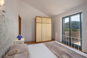 Postel nebo postele na pokoji v ubytování Apartments Lapida