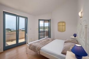 Postel nebo postele na pokoji v ubytování Apartments Lapida