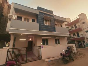 two motorcycles parked in front of a house at KBS Home Ramapuram in Chennai +13 photos