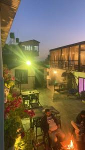 a person sitting on a patio at night at Aati cafe in Pokhara