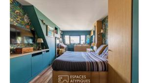a small bedroom with a bed and a fish tank at Paris Best view w/Rooftop! in Paris