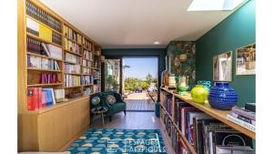 a library with bookshelves and a green wall at Paris Best view w/Rooftop! in Paris +7 photos