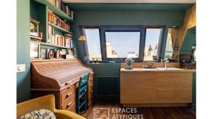 a bathroom with a sink and a desk and a window at Paris Best view w/Rooftop! in Paris