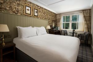 a bedroom with a large white bed in a room at The Ullswater Inn- The Inn Collection Group in Glenridding