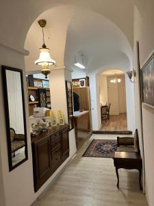 a hallway with an archway with a table and chairs at Hotel Post 12 in Braunau am Inn +24 photos