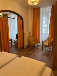 a hotel room with two beds and a mirror at City Hotel Post 12 in Braunau am Inn