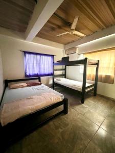 a bedroom with two bunk beds and a window at Apartamentos Coveñas in Coveñas