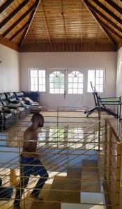 a young boy standing inside of a volleyball cage at Bell Air Seaview (3 BDRM 3 BATH) in Runaway Bay