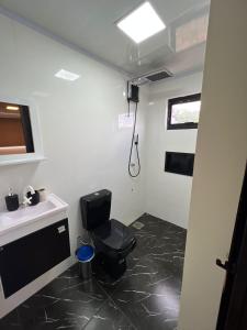 a bathroom with a toilet and a sink at Container Home Py in Puerto Presidente Franco